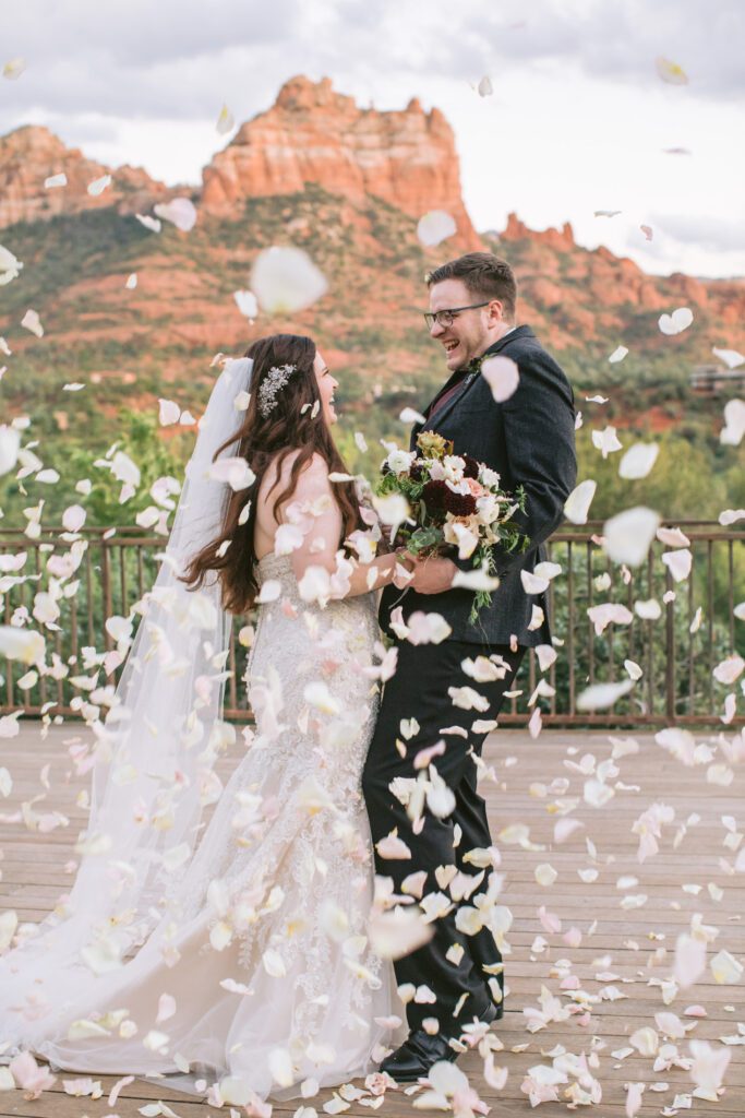 Flower petals are thrown at newly weds after their wedding ceremony at L'Auberge